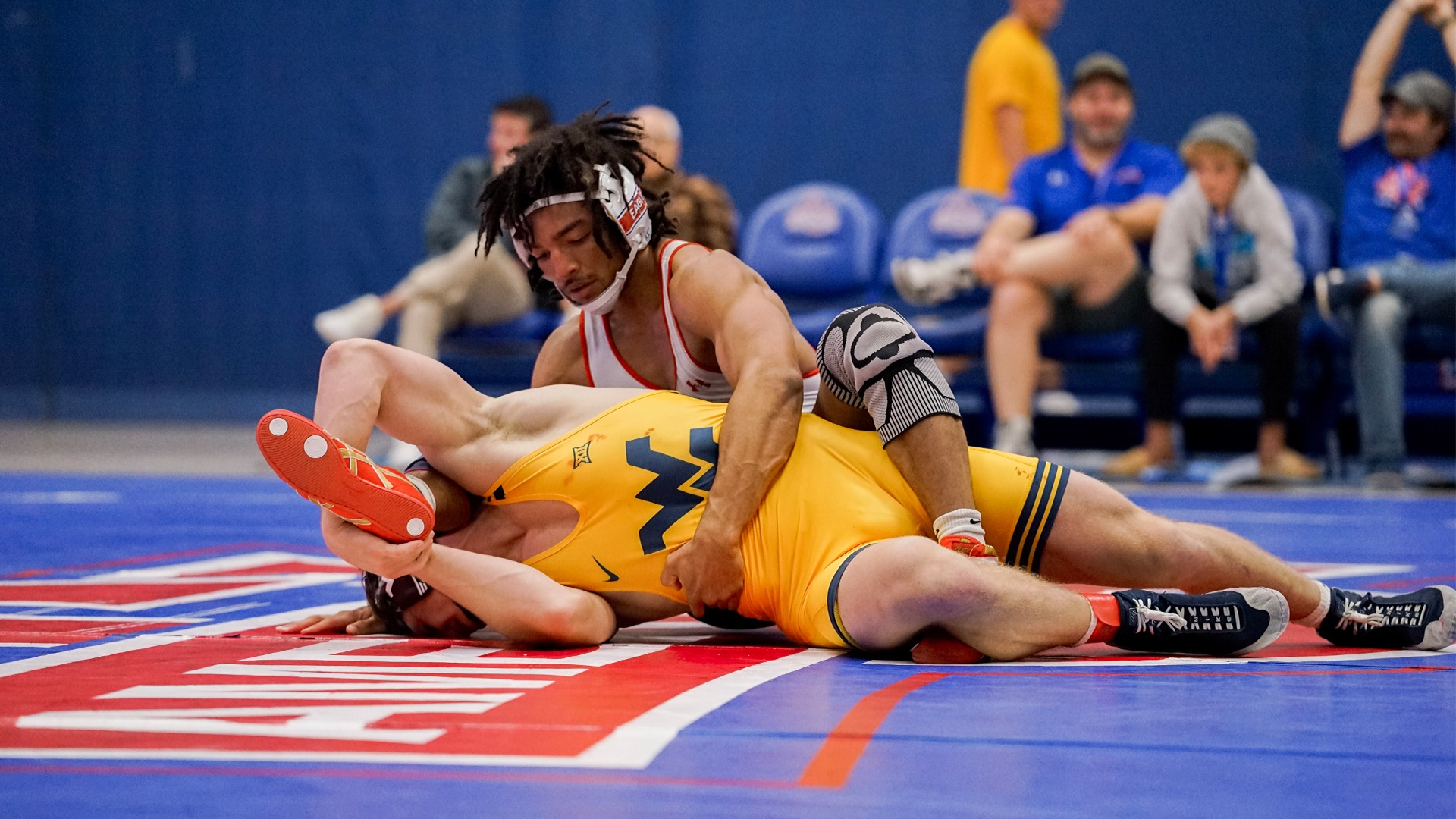Caleb Campos wrestling in a match against West Virginia. 