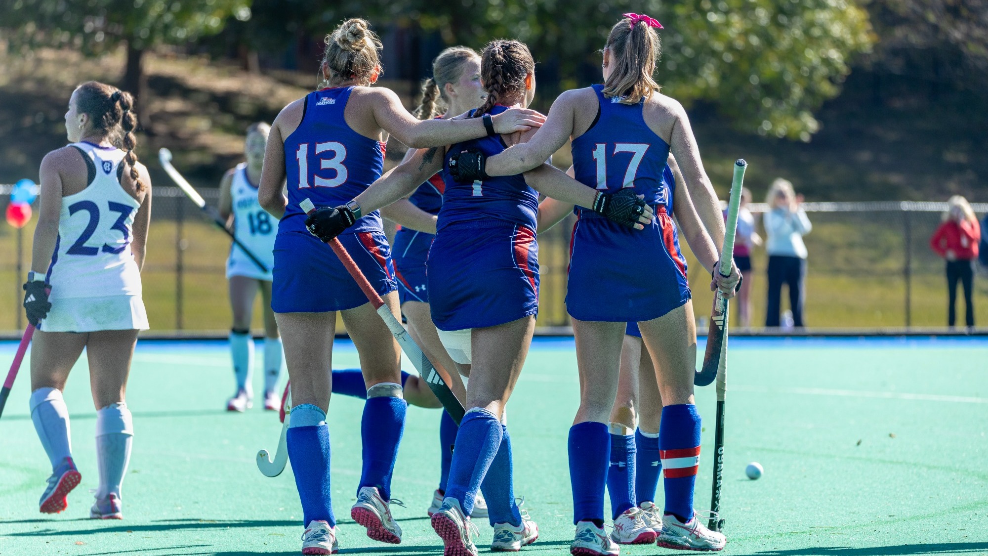Riley Clouse, Kaleigh Missimer, Emilia Winkler with their arms around each other after Missimer scored a goal