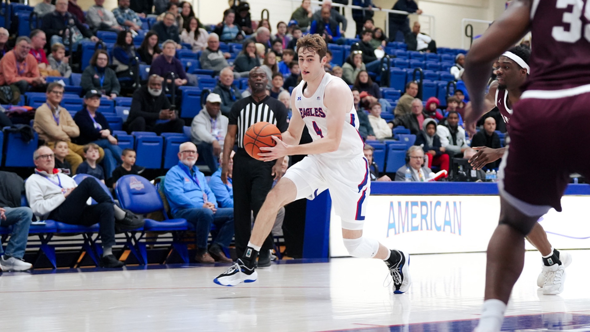 Kade Sebastian dribbling in a men's basketball game