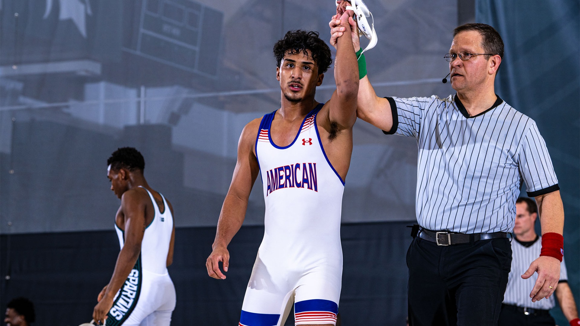 Leo Maestas getting his arm raised after winning a match against Michigan State.