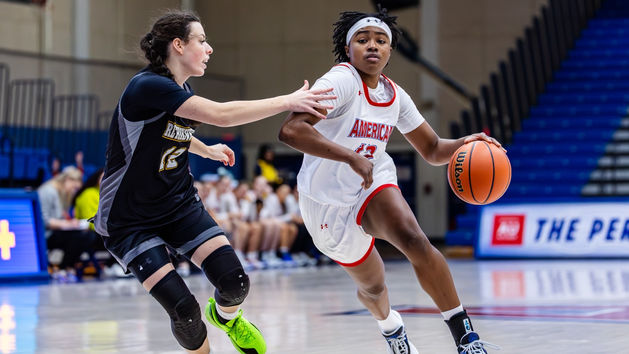 Madisyn Moore-Nicholson driving with the ball to the basket against UMBC.