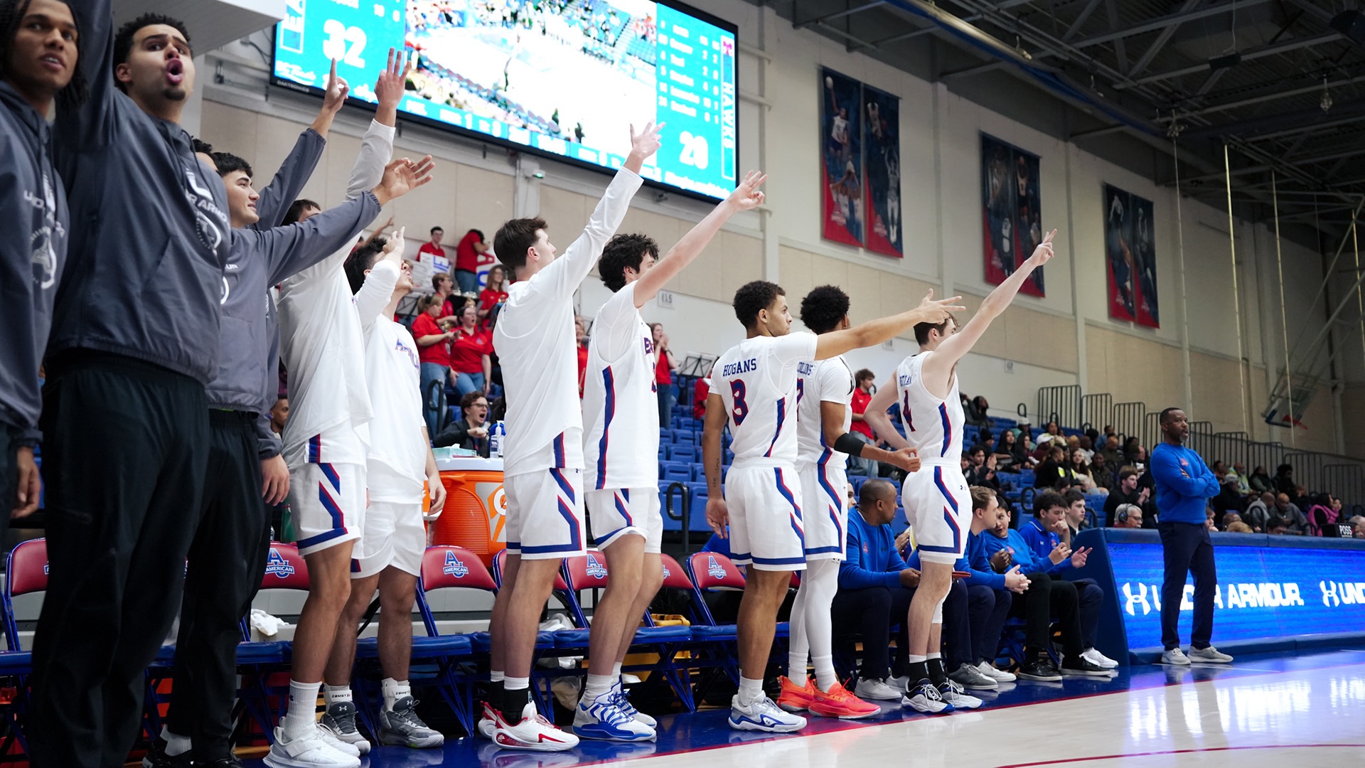 men's basketball bench celebrating during a game