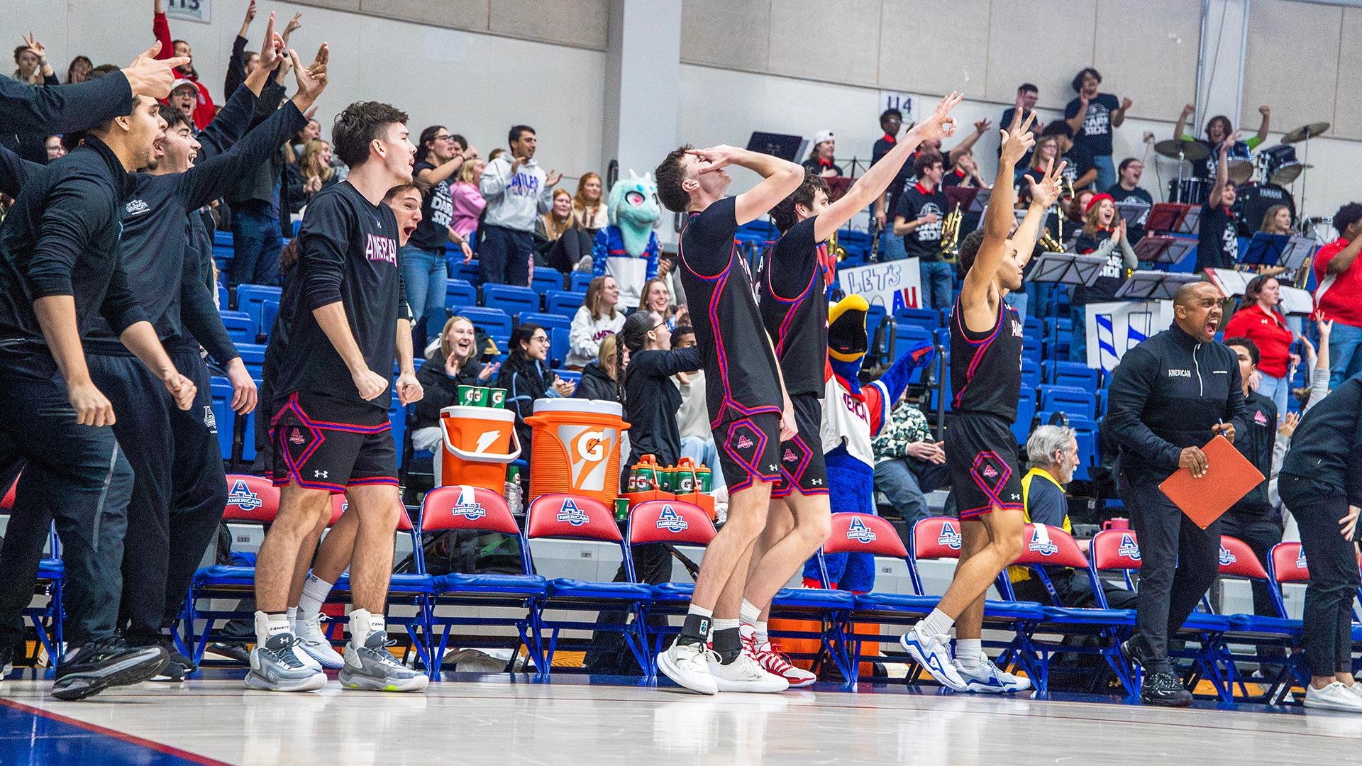 men's basketball bench celebrating during a comeback win against Drexel