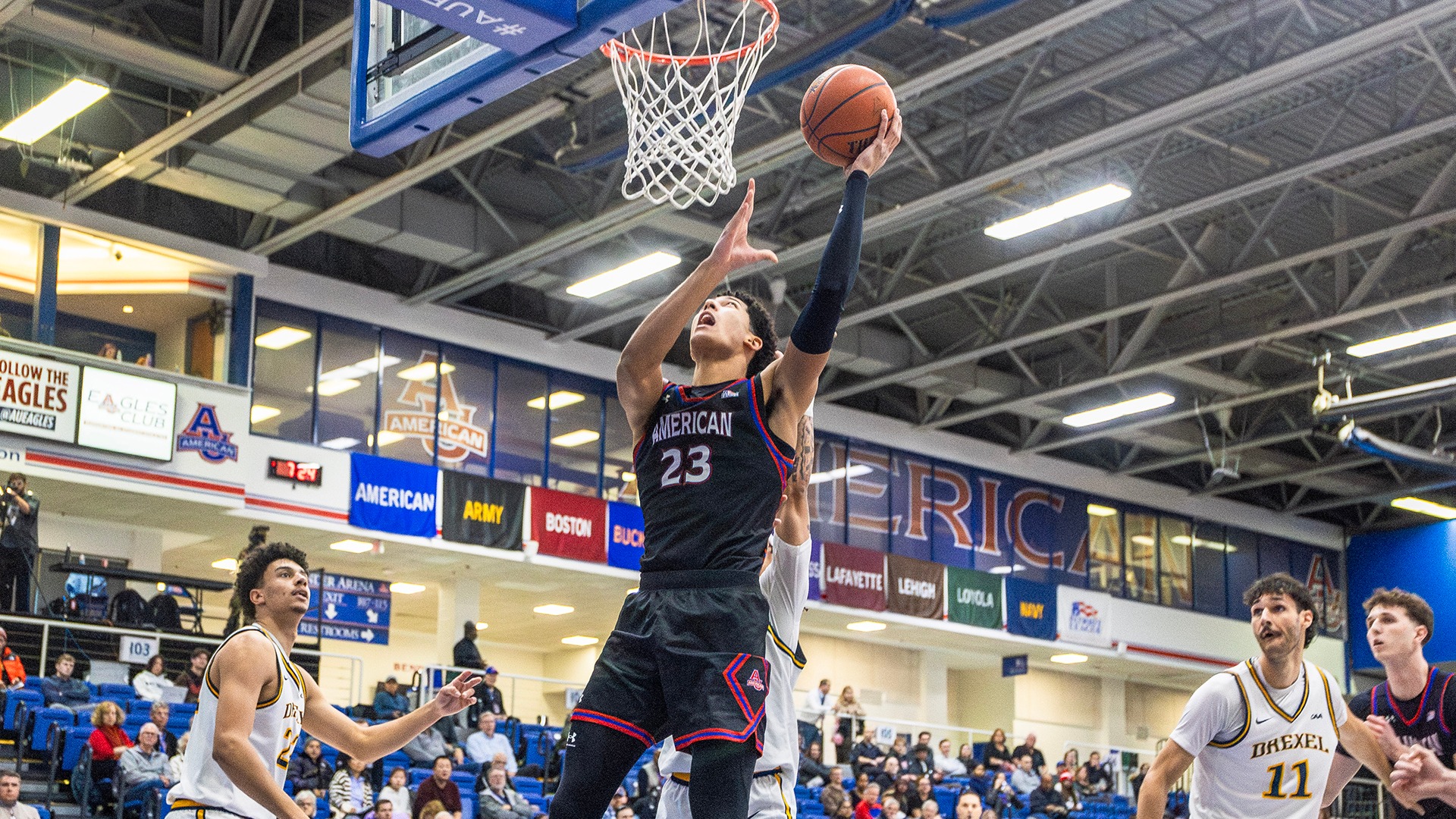 Greg Jones going up for a basket in a men's basketball game