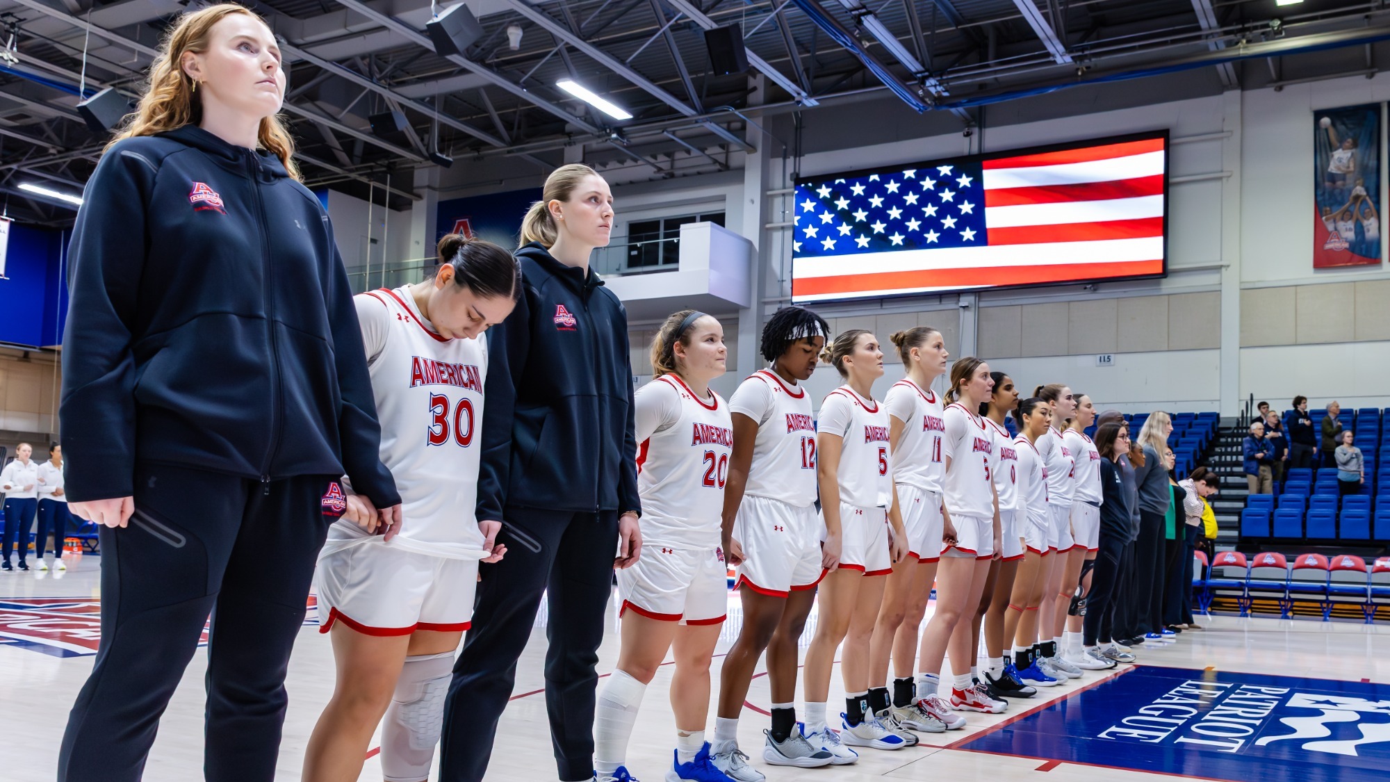 Women's Basketball lined up on the court in Bender Arena during the national anthem