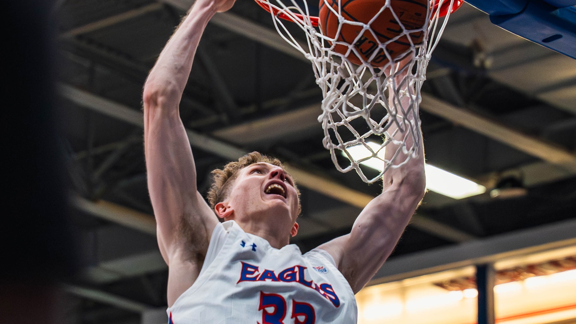 Matt Mayock dunking the ball in a men's basketball game