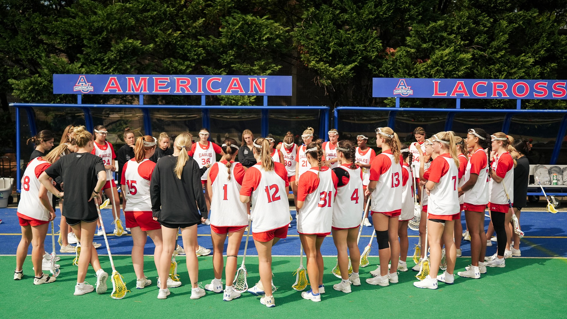 The lacrosse team huddled on the sideline before a fall ball game against VCU. 