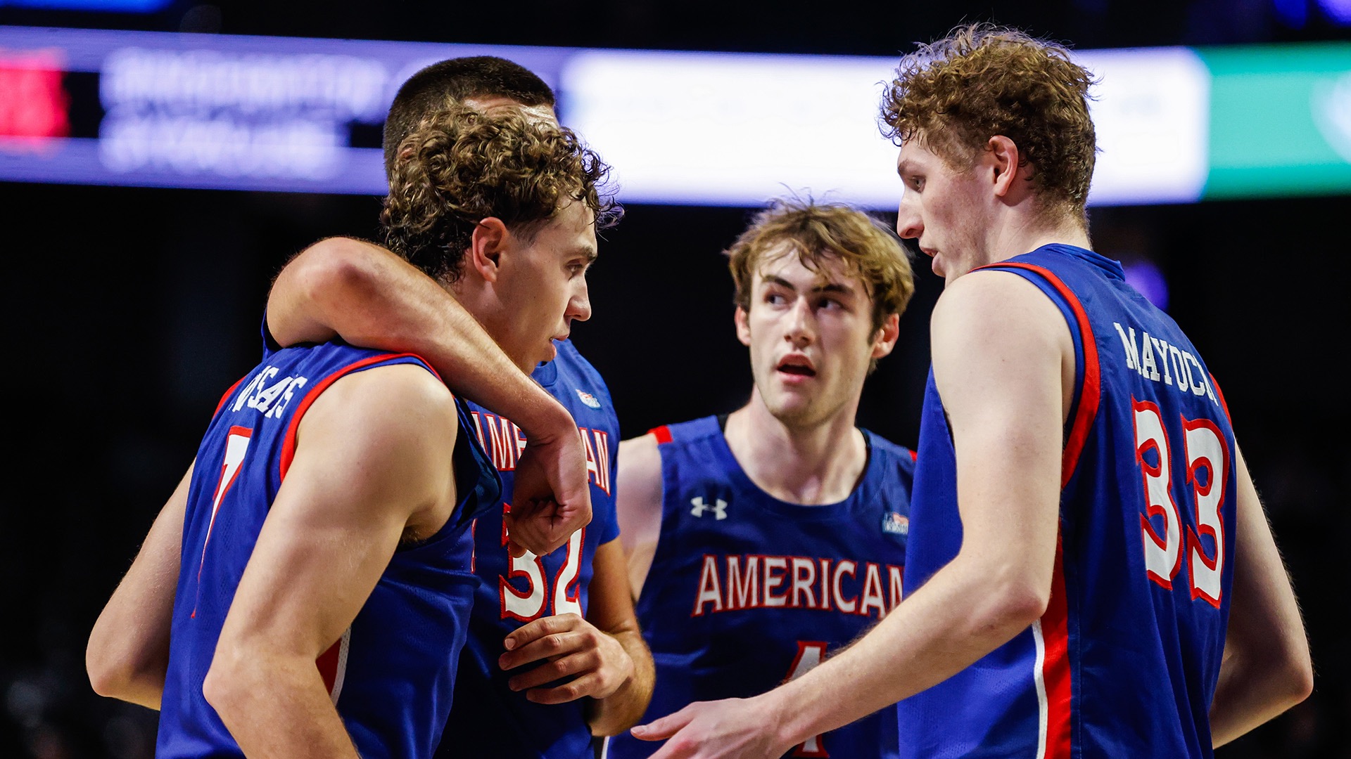 men's basketball players huddled during a game