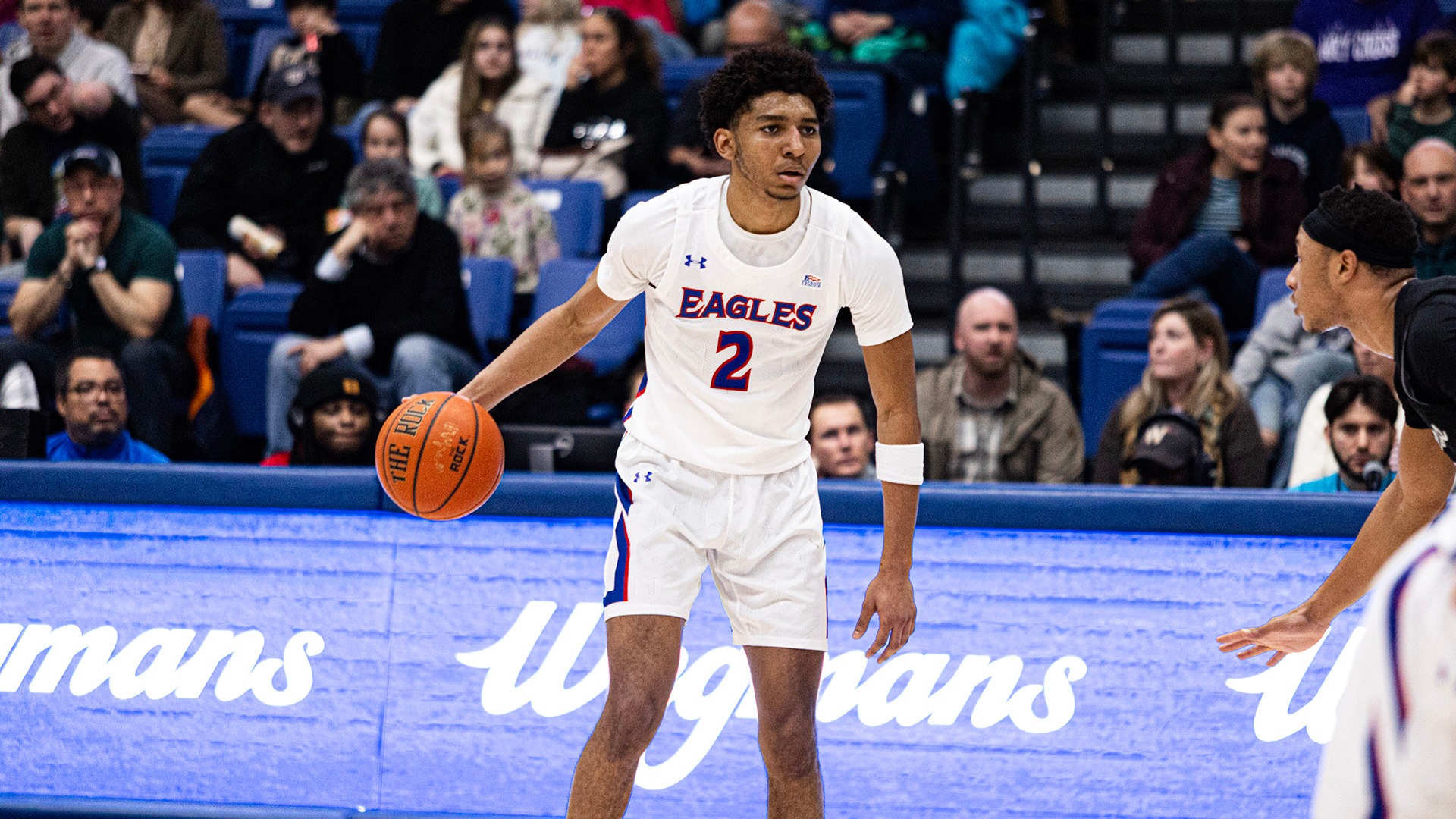Madden Collins with the ball during a men's basketball game against Holy Cross