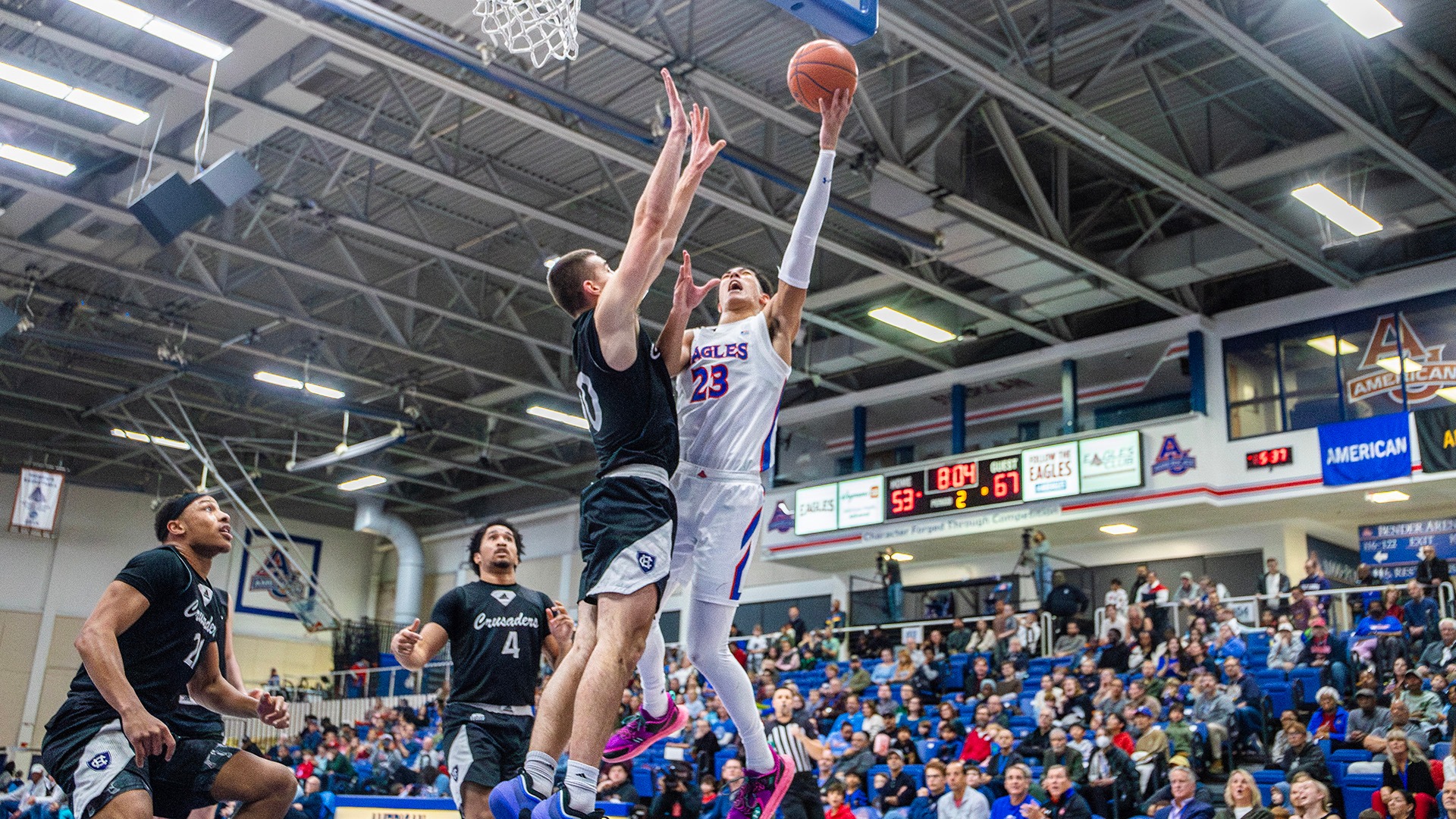 Greg Jones going up for a shot in a men's basketball game against Holy Cross