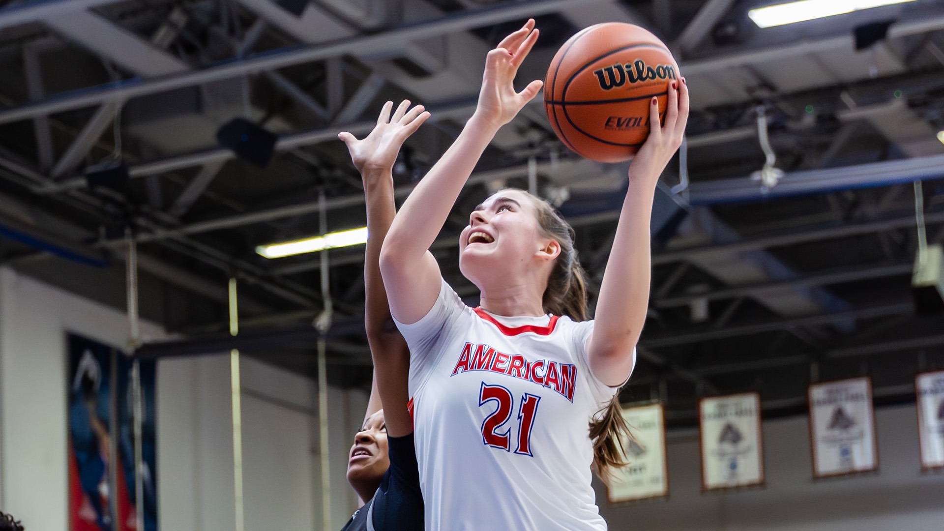 Charlotte Tuhy taking a shot in a women's basketball game
