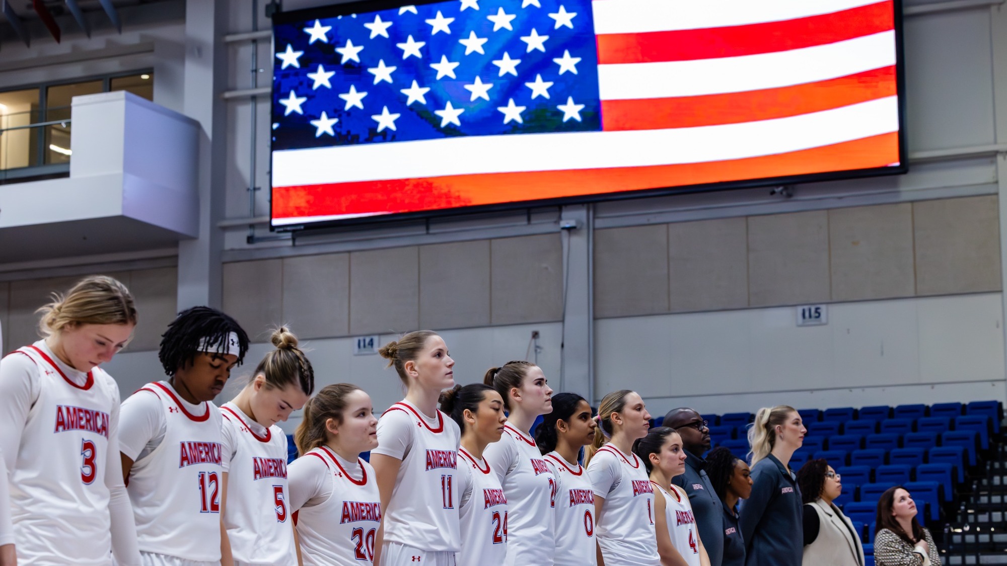 Women's Basketball lined up on the court during the national anthem in Bender Arena.