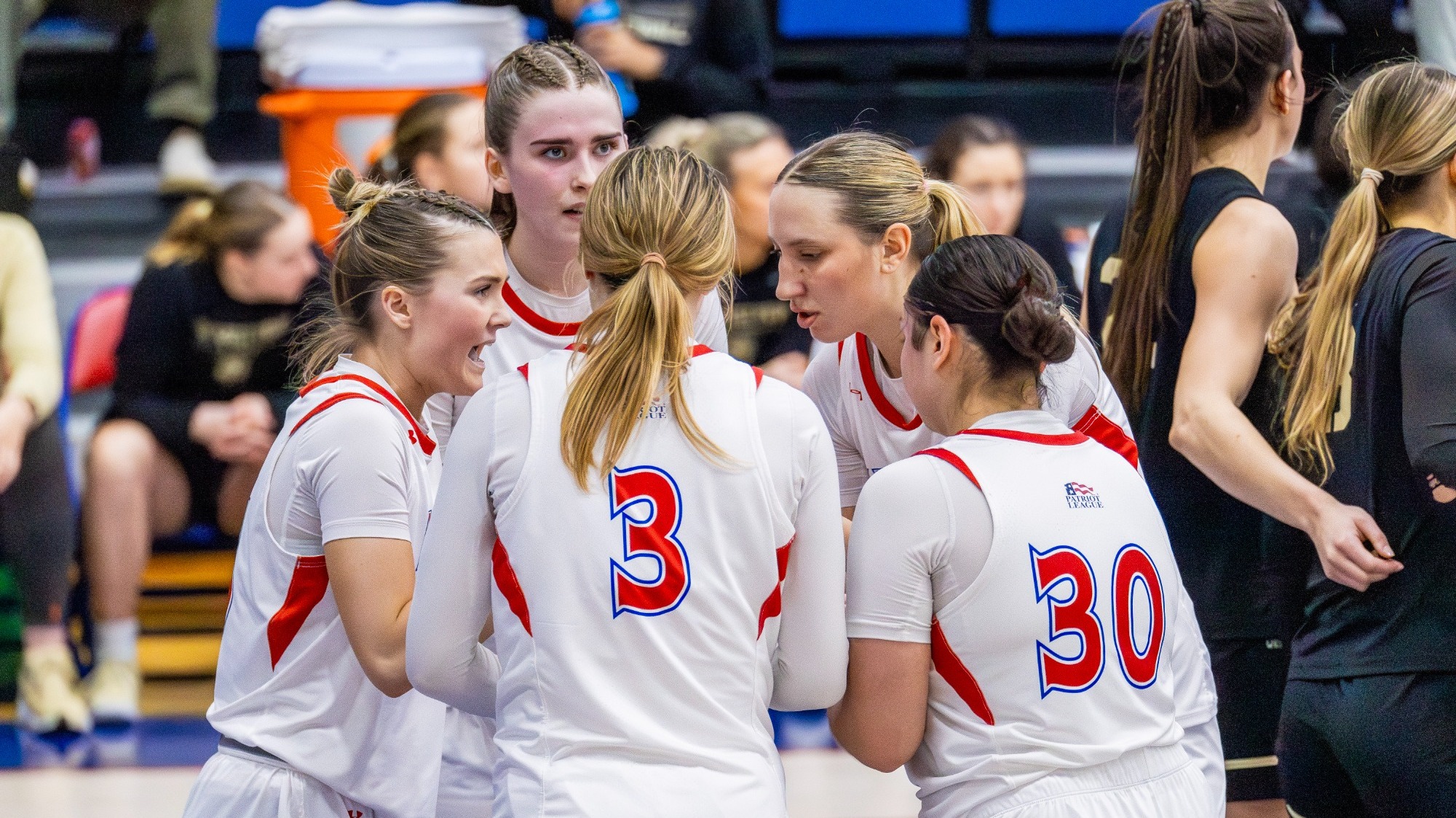 Women's Basketball Huddles together on the court against Army. 