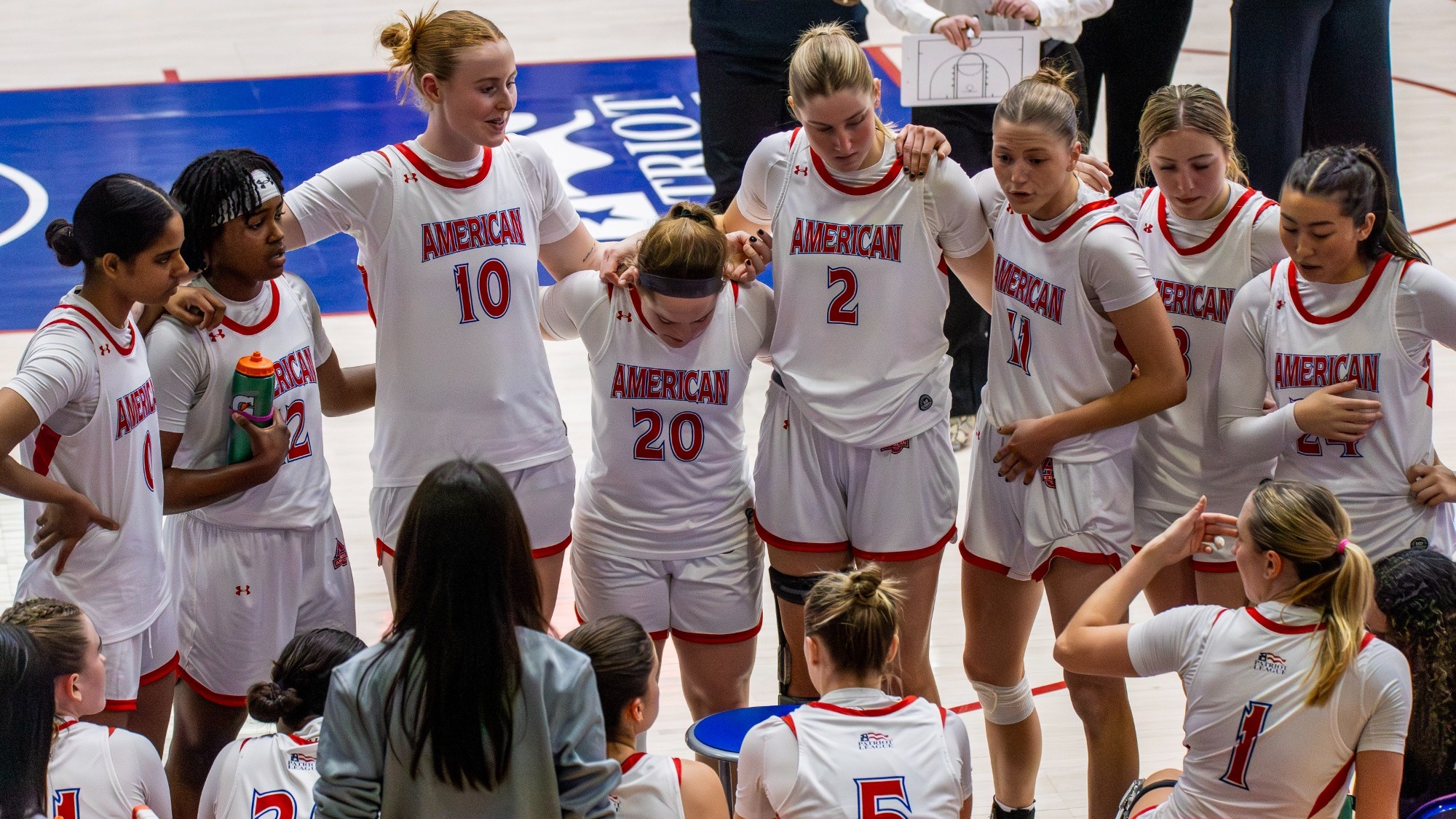 Women's basketball huddles together during a timeout against Army in Bender Arena.