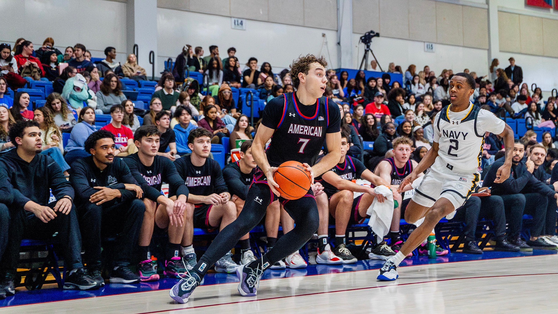 Wyatt Nausadis with the ball during a men's basketball game against Navy in Bender Arena