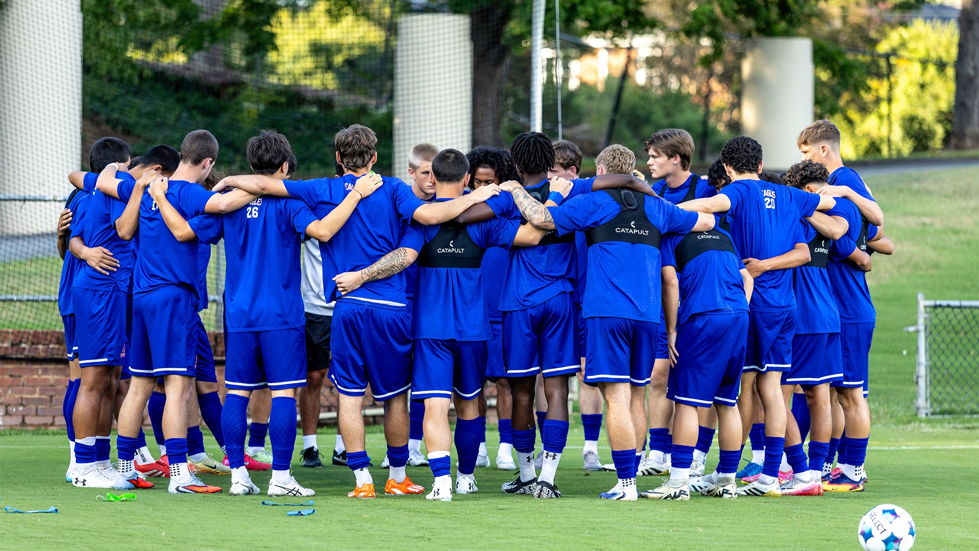 The Men's Soccer team in a huddle before a match. 