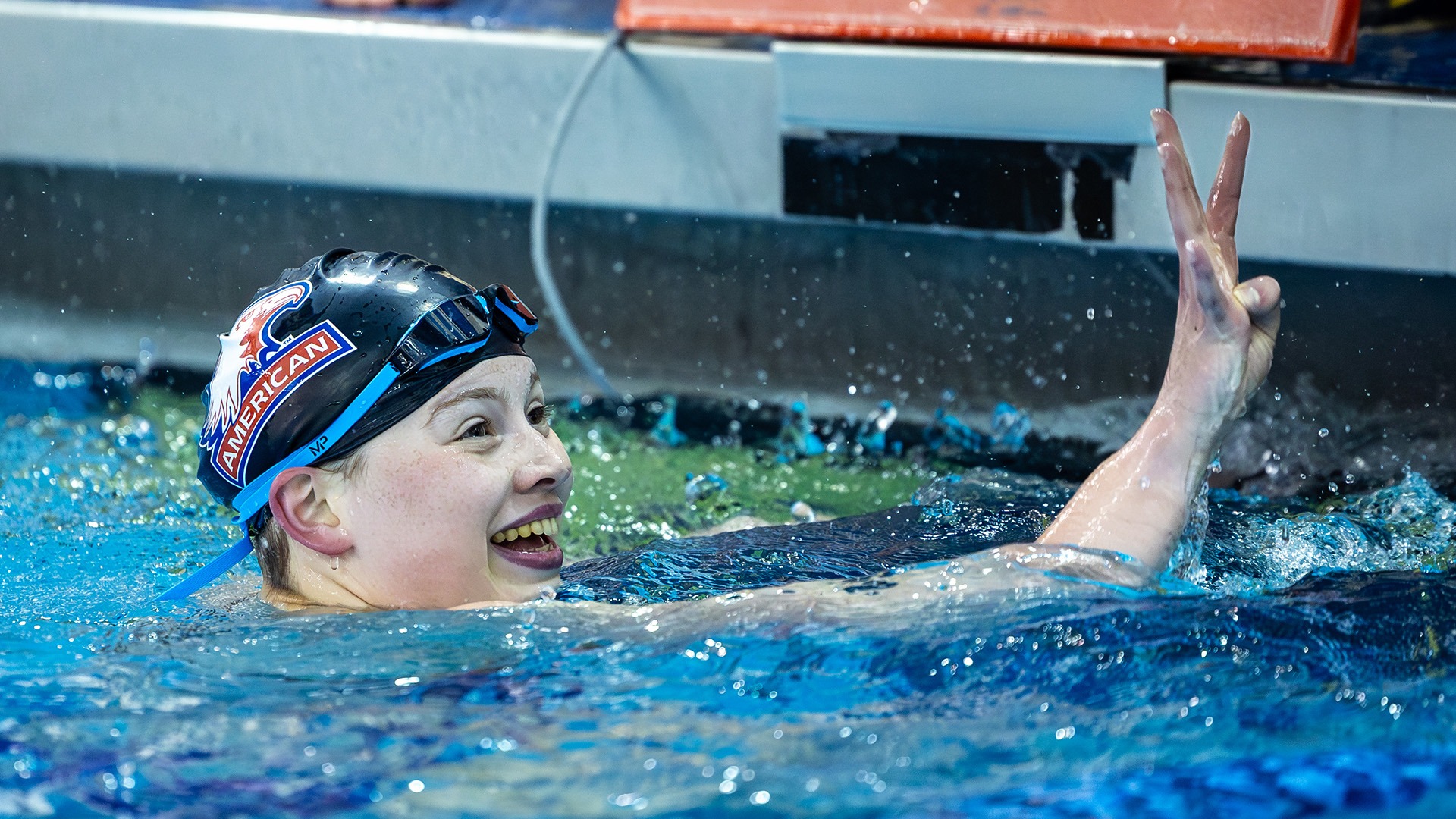 Kate Williams celebrating a win for women's swimming