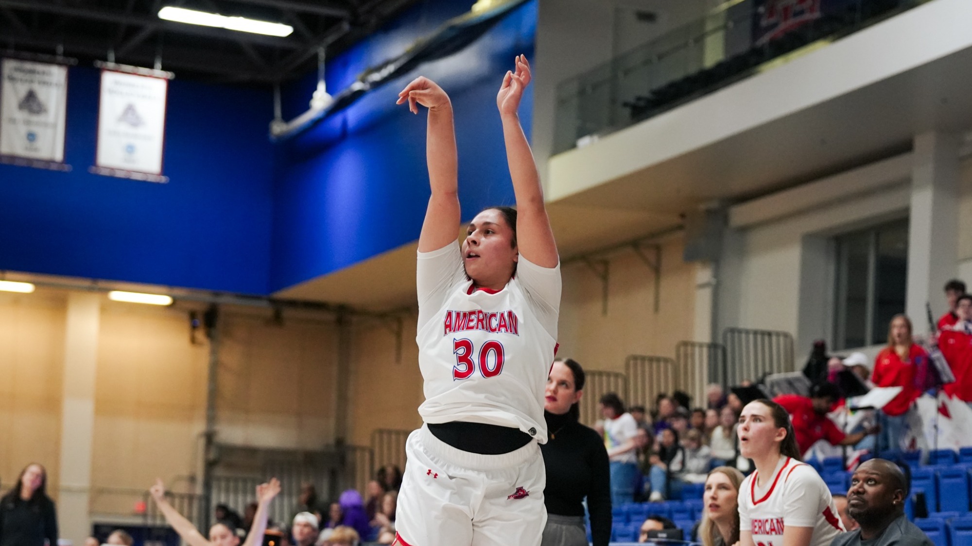 Lexi Salazar taking a three point shot against Holy Cross.