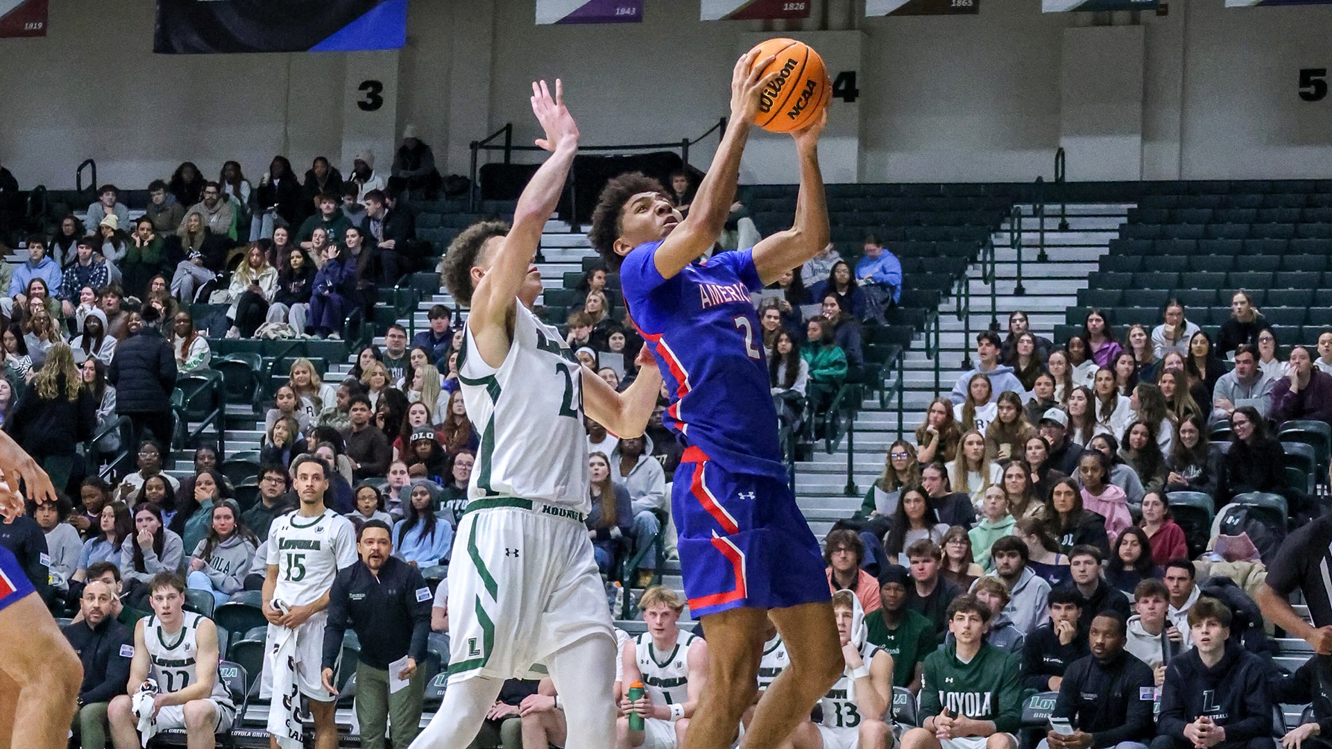Madden Collins taking a layup in a men's basketball game at Loyola Maryland