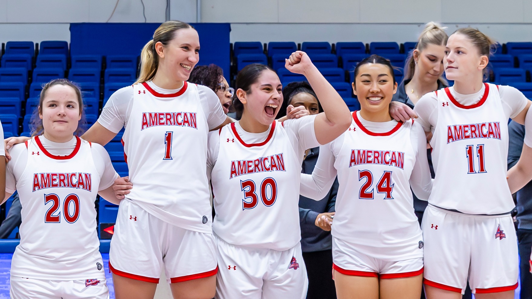 Women's basketball celebrates a win over Boston University.