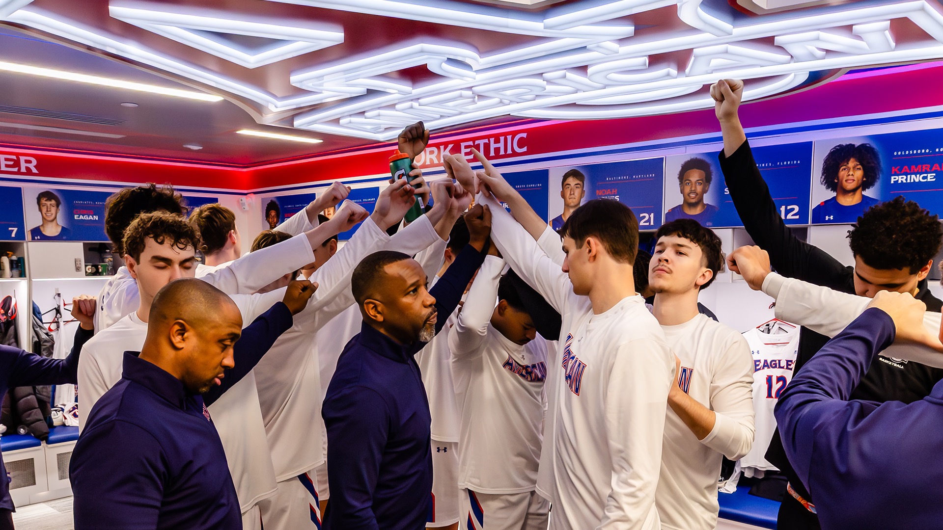 men's basketball team huddled in the locker room