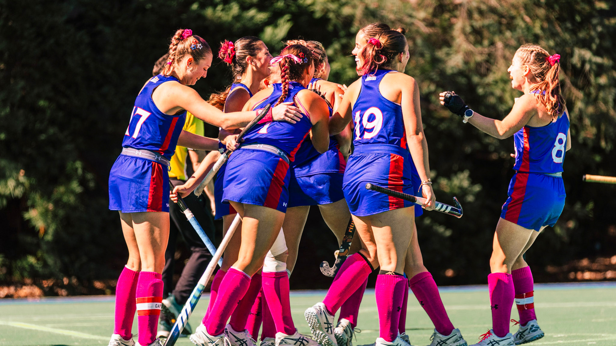 Field Hockey celebrating a goal over Georgetown.