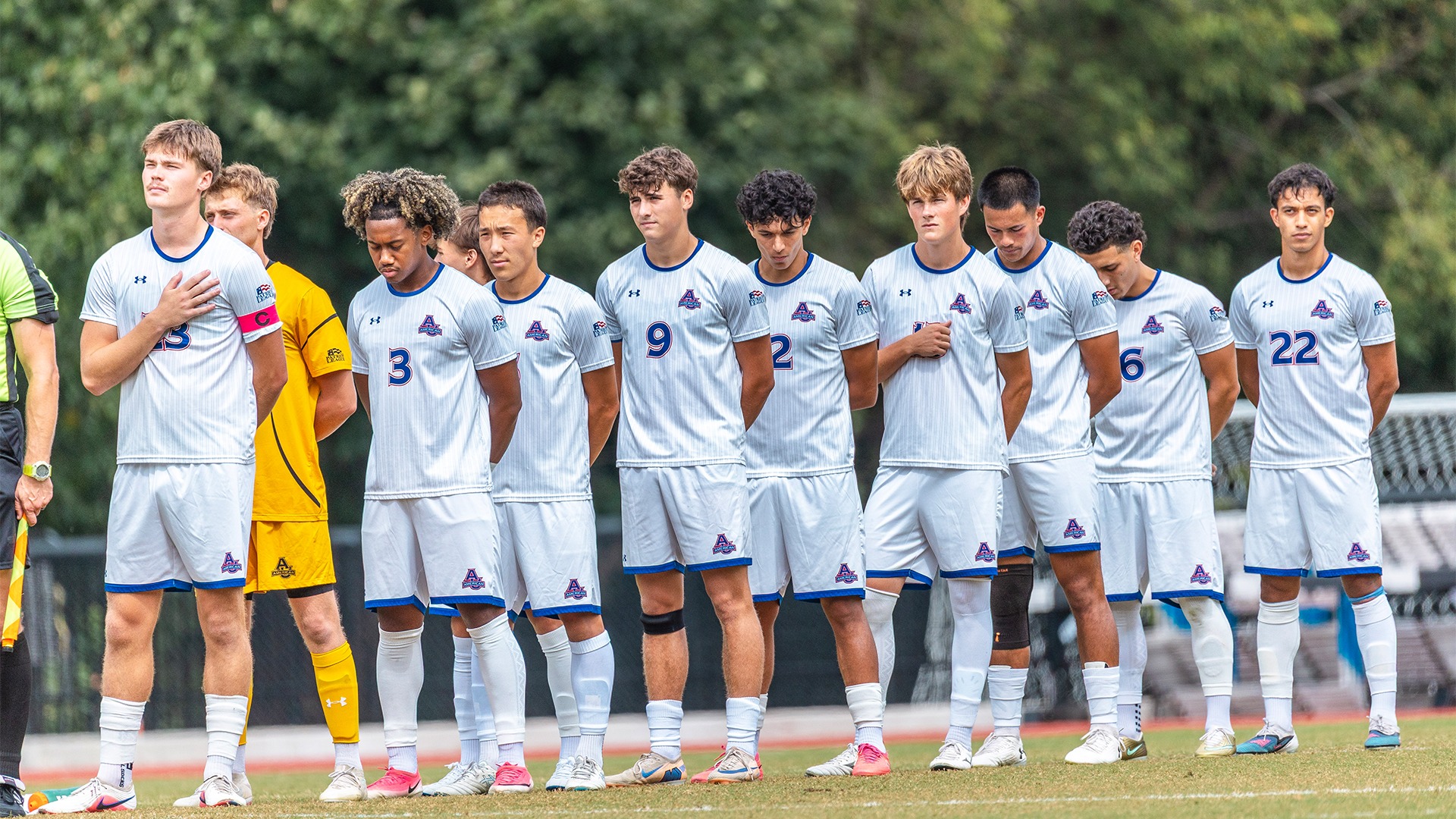 The men's soccer team during the national anthem. 