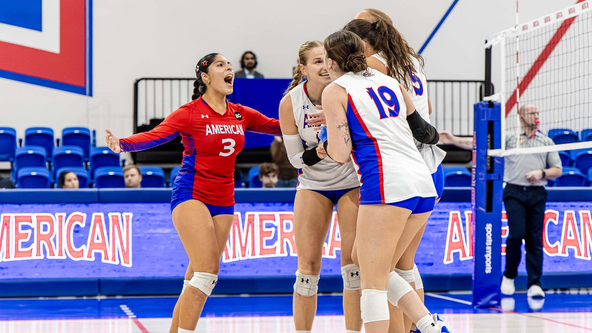 The volleyball team celebrating a point.