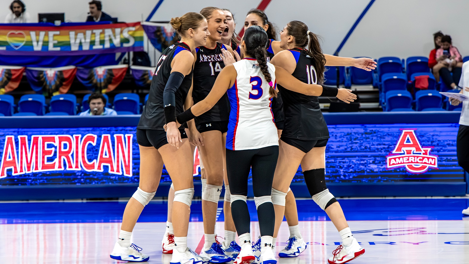 The volleyball team celebrating a point.