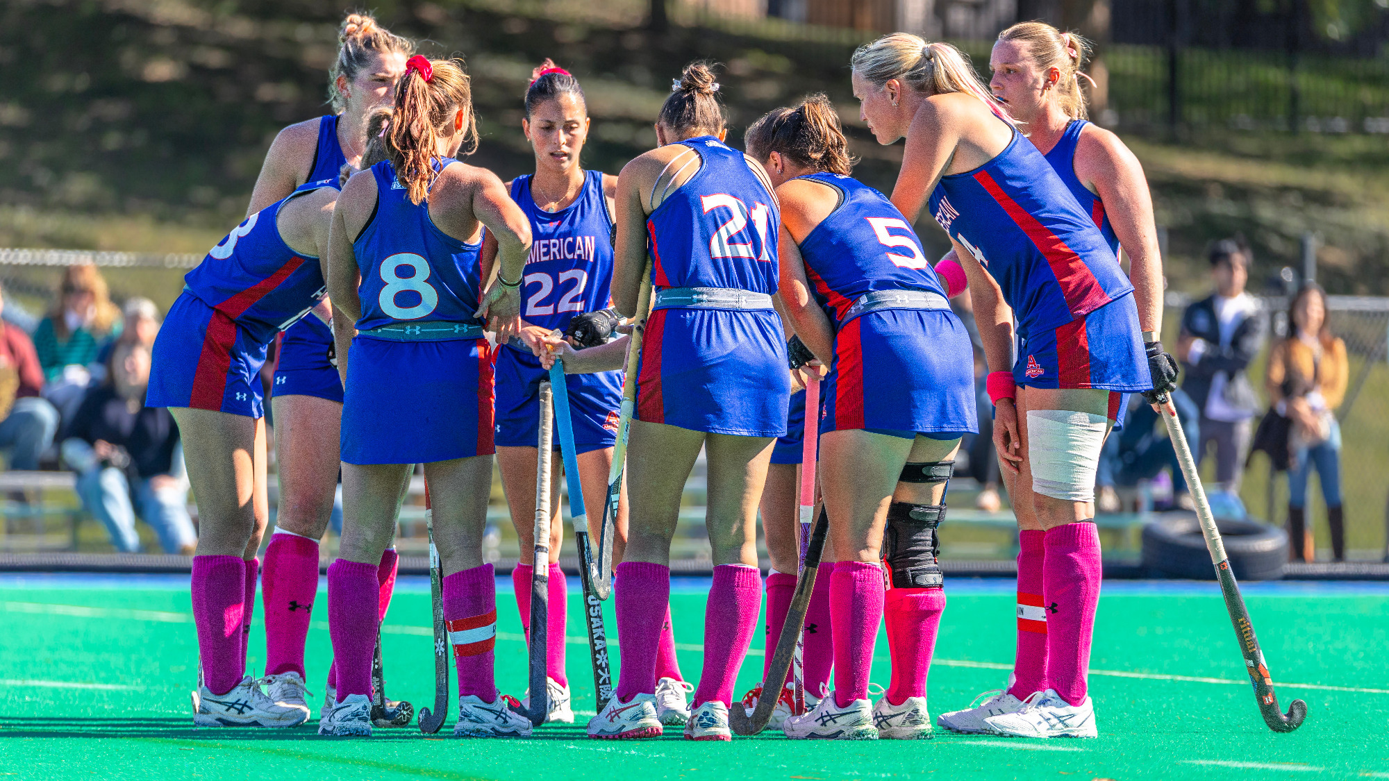 Field hockey huddles together during a game against Georgetown
