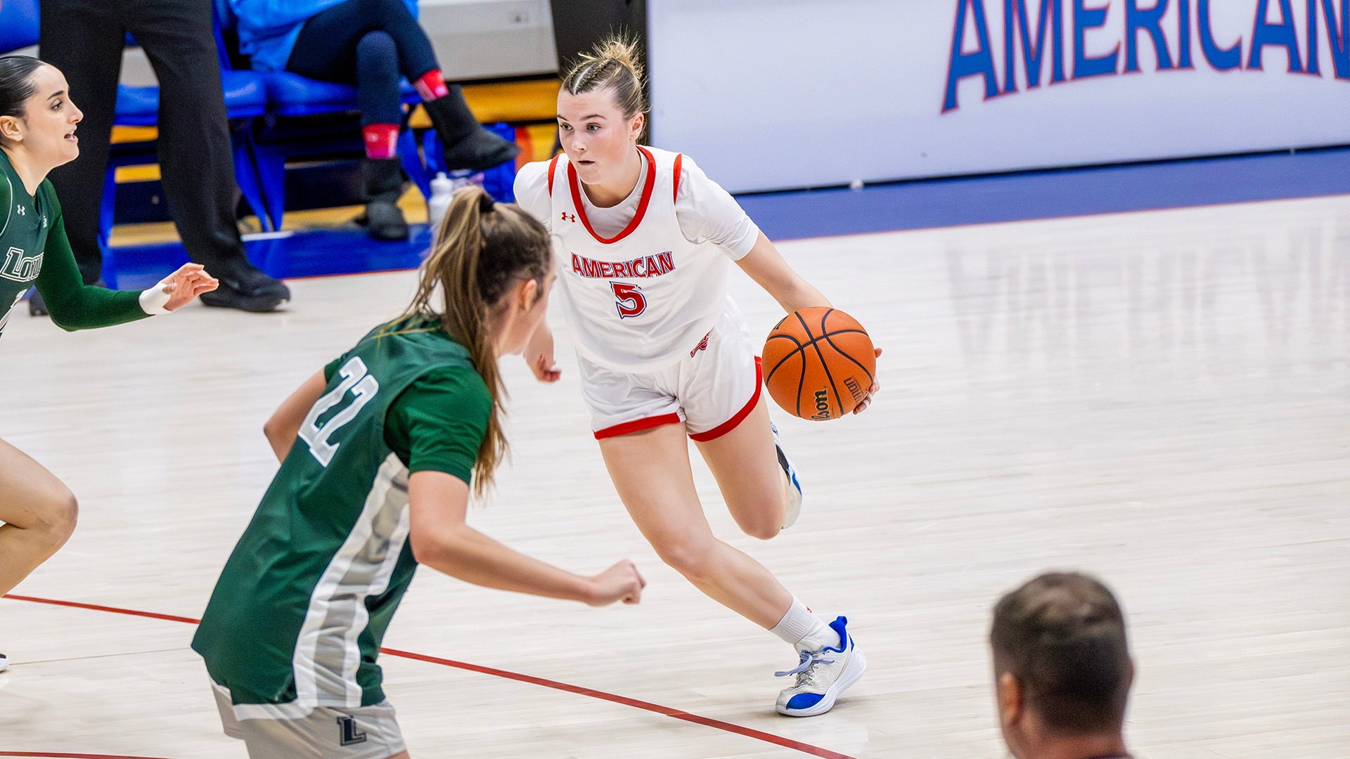 Molly Driscoll dribbling the ball in a women's basketball game