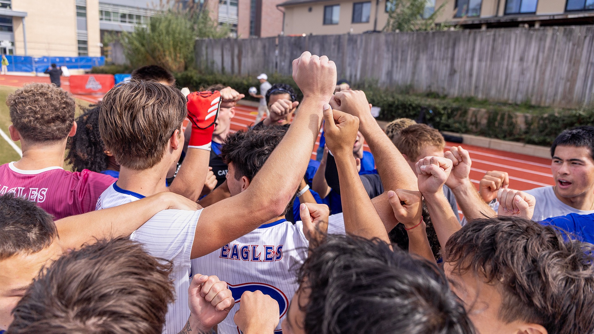 The men's soccer team in a huddle before a match. 