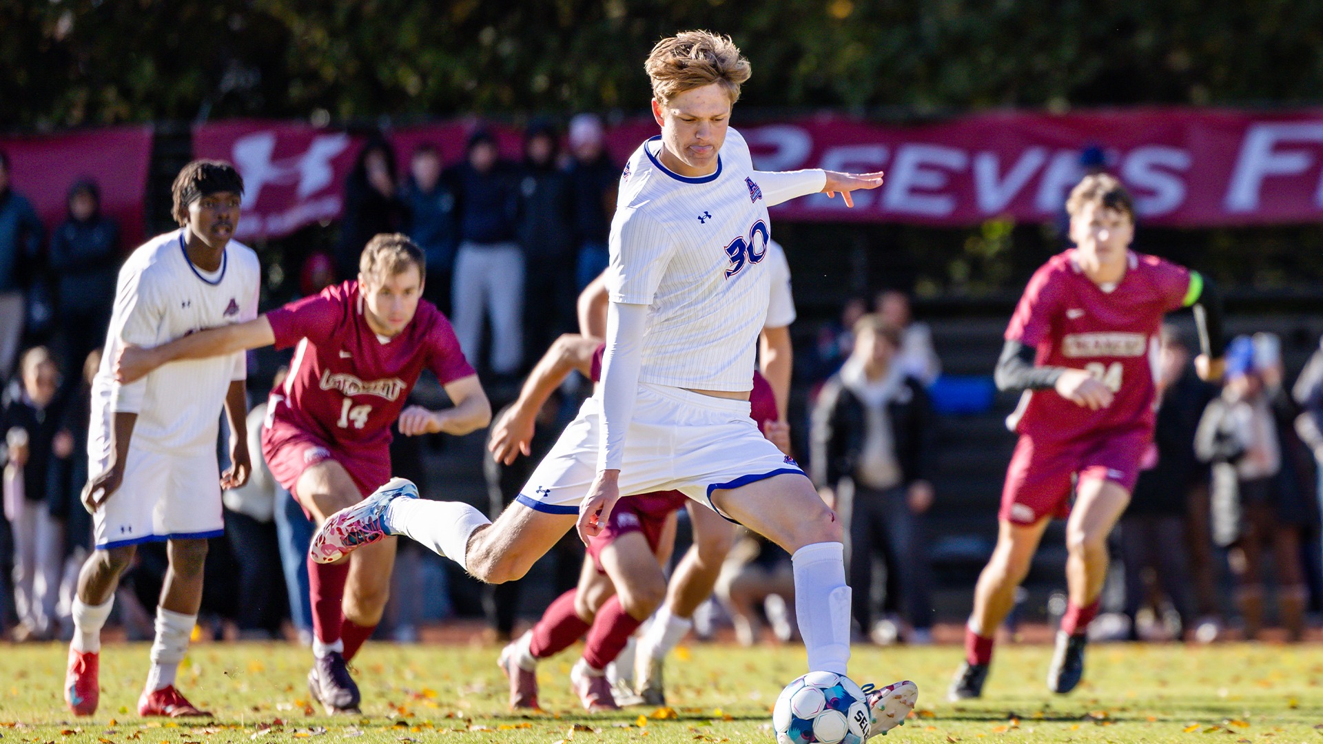 Troy Elgersma kicking a ball in a game against Lafayette. 