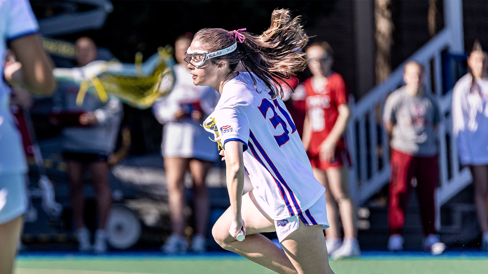 Shannon Silvius running with the ball in a lacrosse game against Temple.