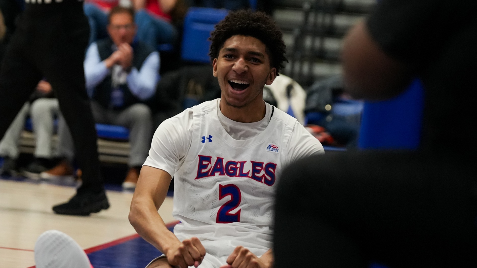 Madden Collins celebrating after a great shot in a men's basketball game