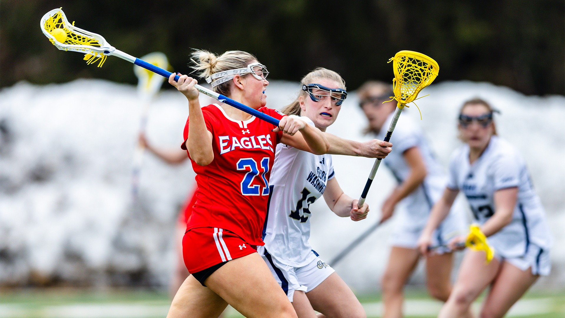 Kellie Linehan shooting the ball in a lacrosse game against GW. 