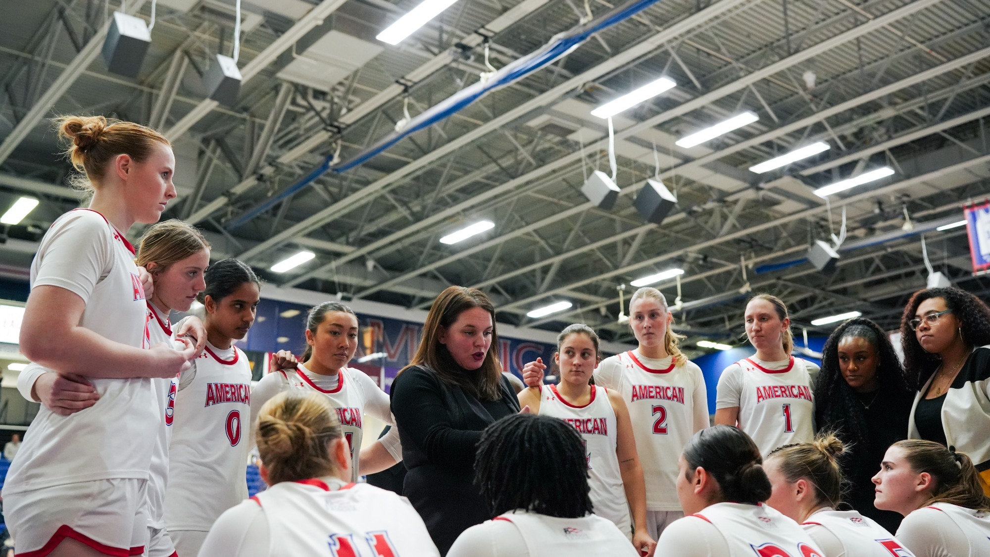 Women's basketball huddles during a timeout against Loyola Maryland.