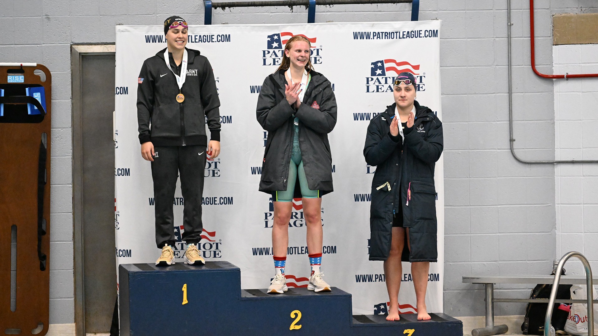 Piper Crosby on the podium with her silver medal in the 100 back at the 2026 PL Swim and Dive Championships