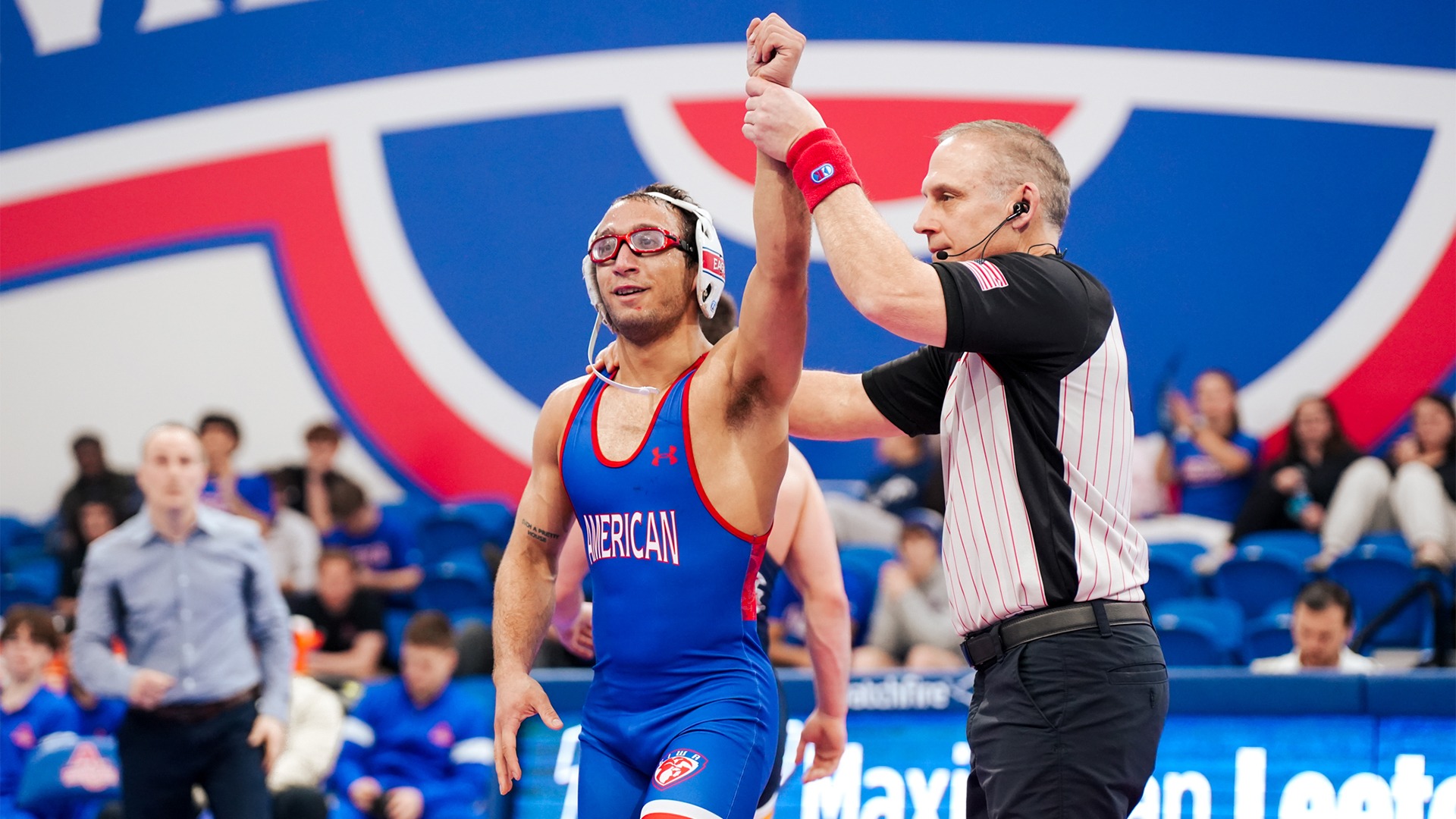 Maximilian Leete getting his arm raised after winning a dual match against Drexel. 