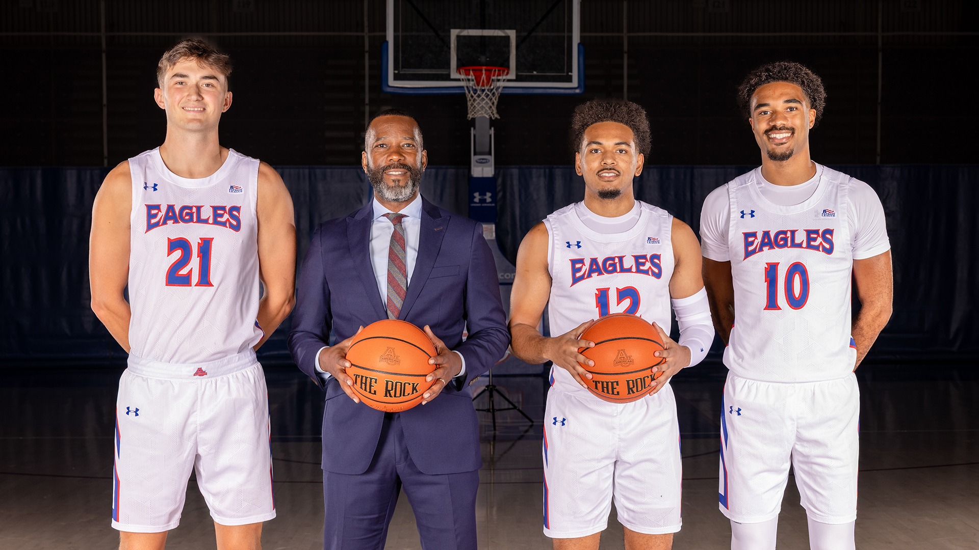 American men's basketball head coach Duane Simpkins with 2025-26 seniors Noah Jones, Adrian Samuels, and Geoff Sprouse