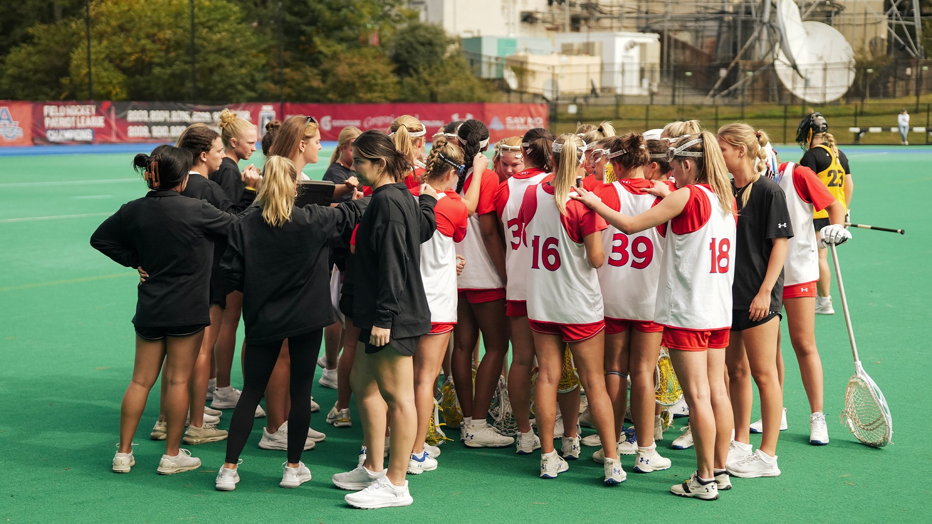 The American University lacrosse team in a huddle during a fall ball scrimmage.