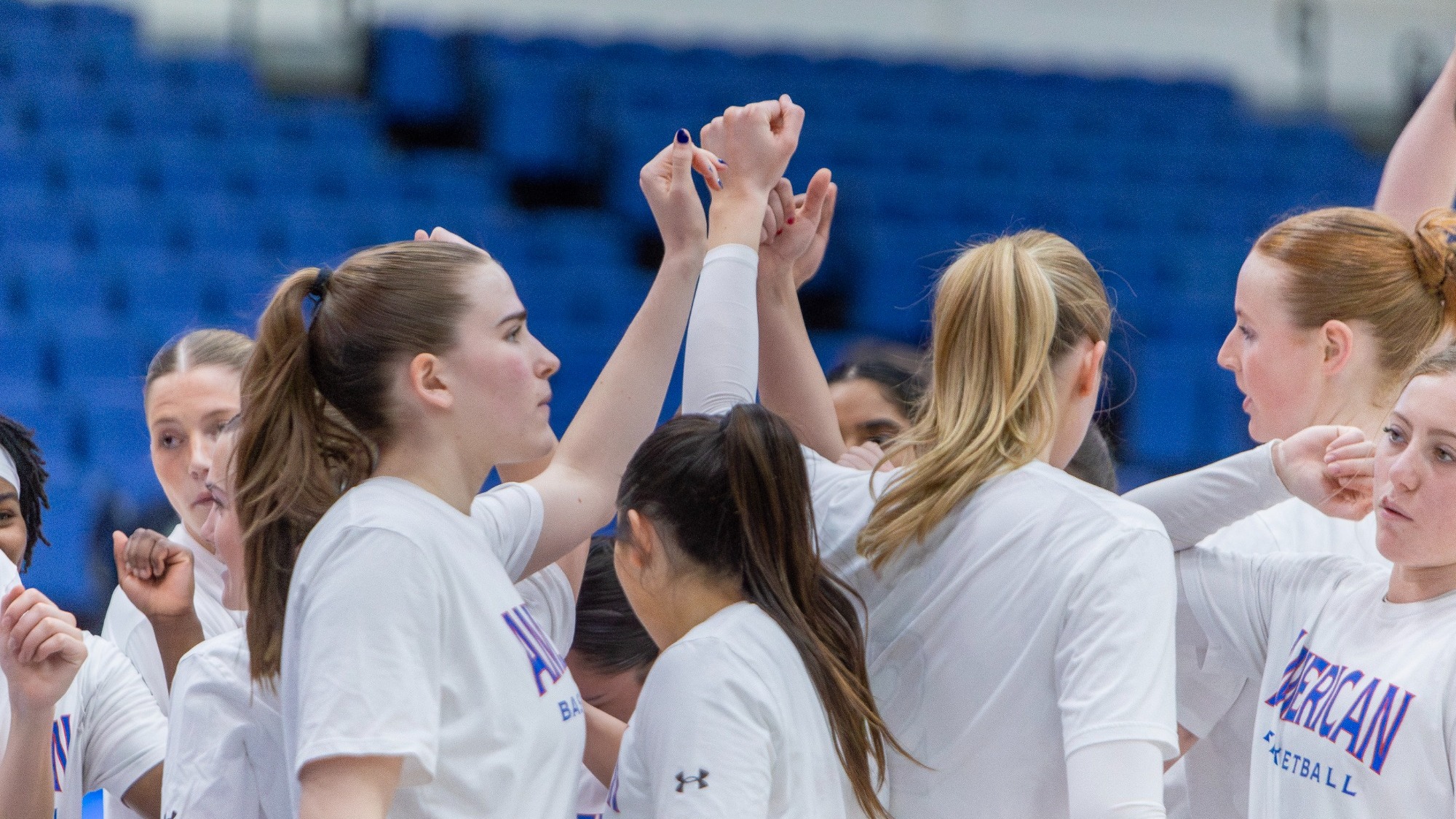 Women's Basketball huddles together on the court in Bender Arena before they take on Loyola.