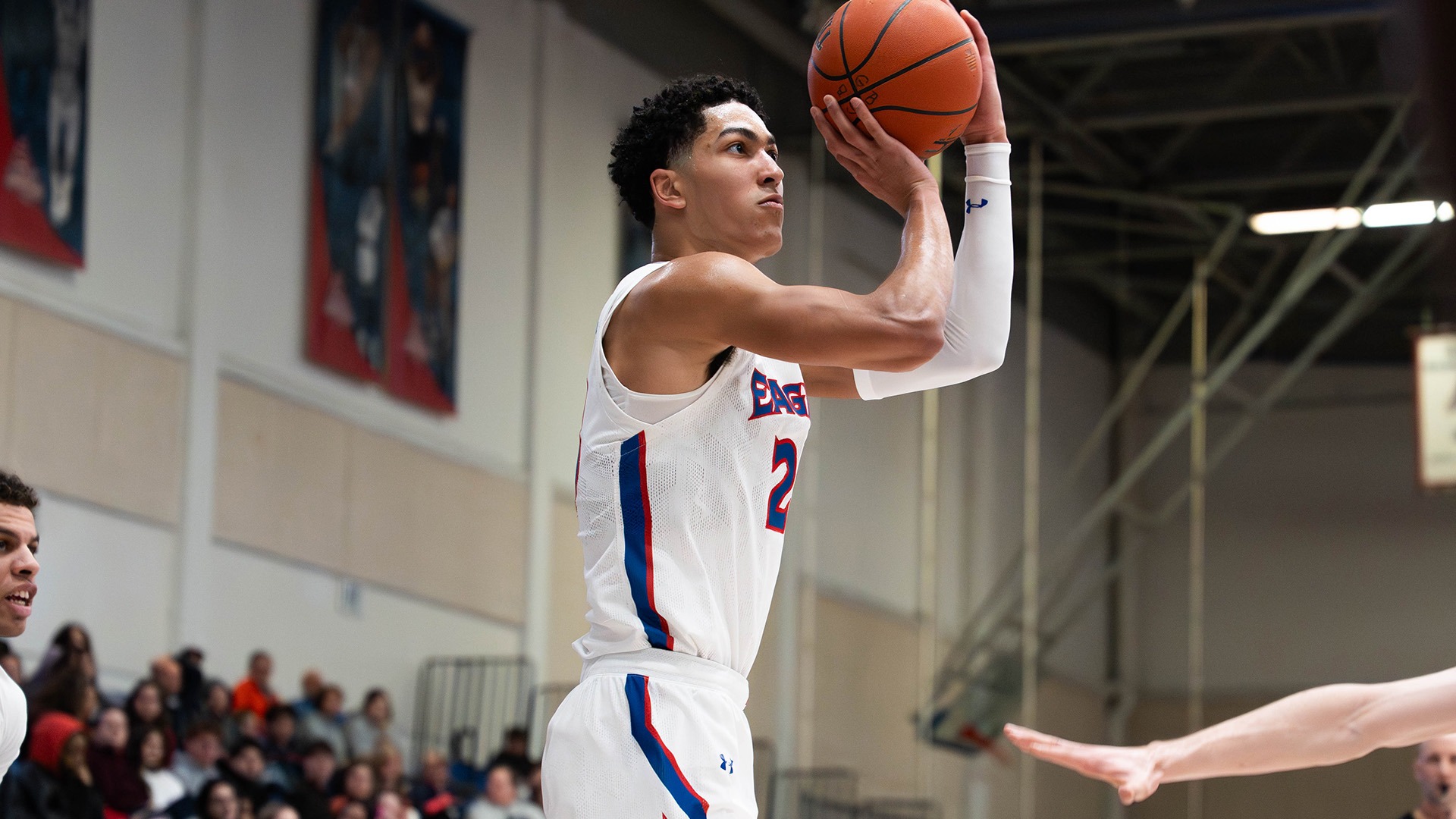 Greg Jones shooting the ball during a men's basketball game at American