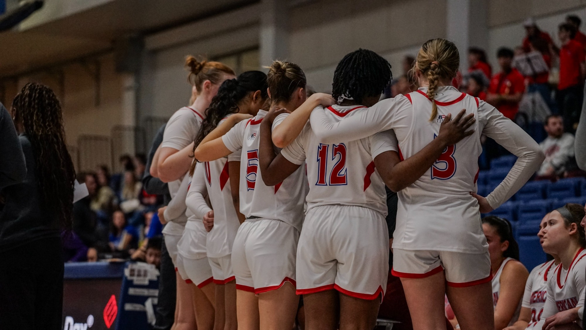 Women's basketball huddles together during a timeout against Navy.