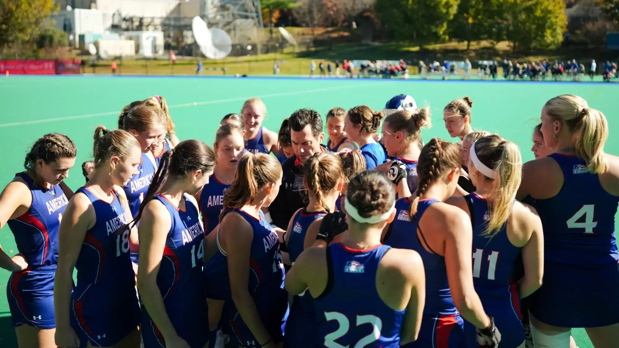 The field hockey team during a pregame huddle