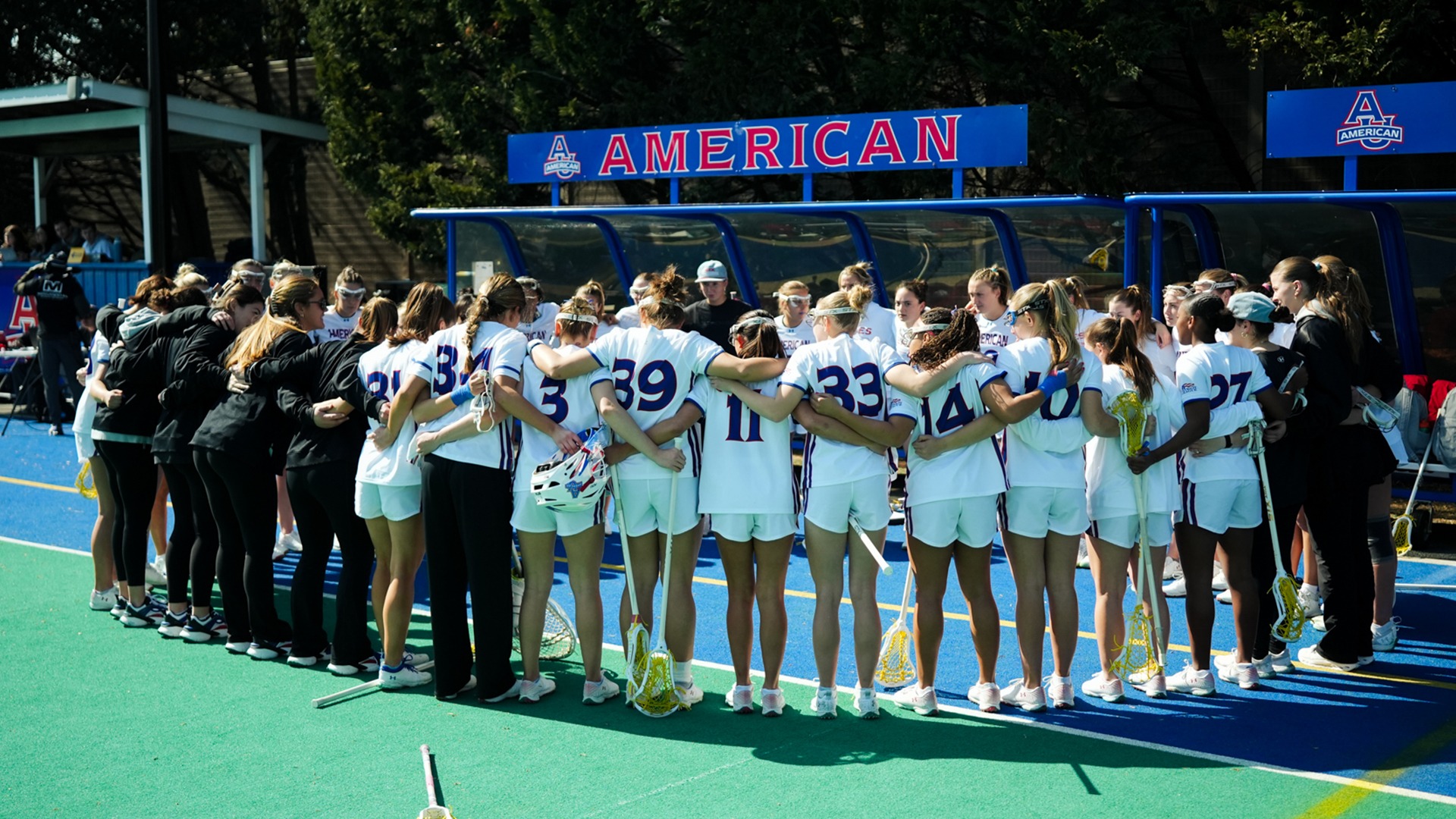 The lacrosse team in a huddle before a game against George Mason.