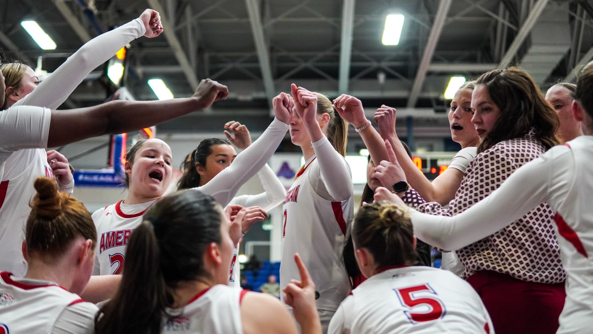 Women's basketball huddled together on the bench during a timeout against Bucknell. 