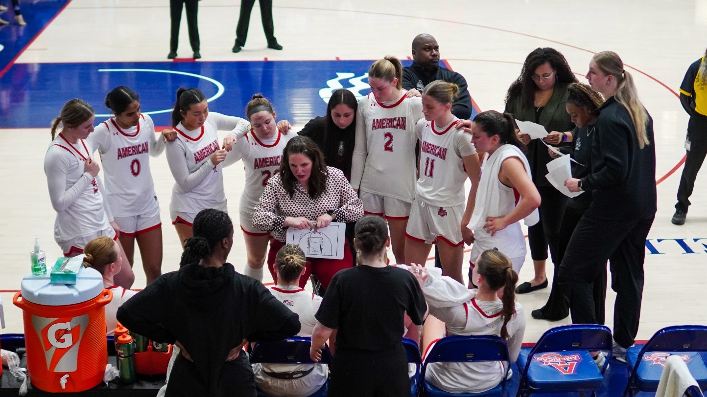 Women's basketball team huddles on the court during a timeout against Bucknell.