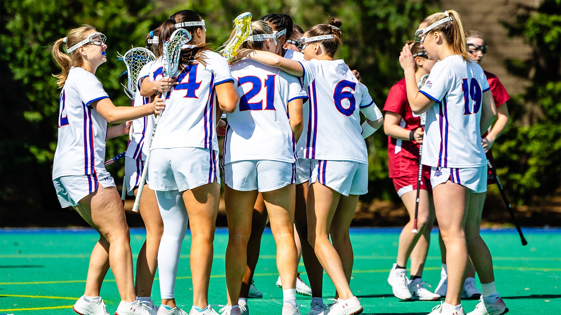 The lacrosse team in a huddle during a game against Colgate. 