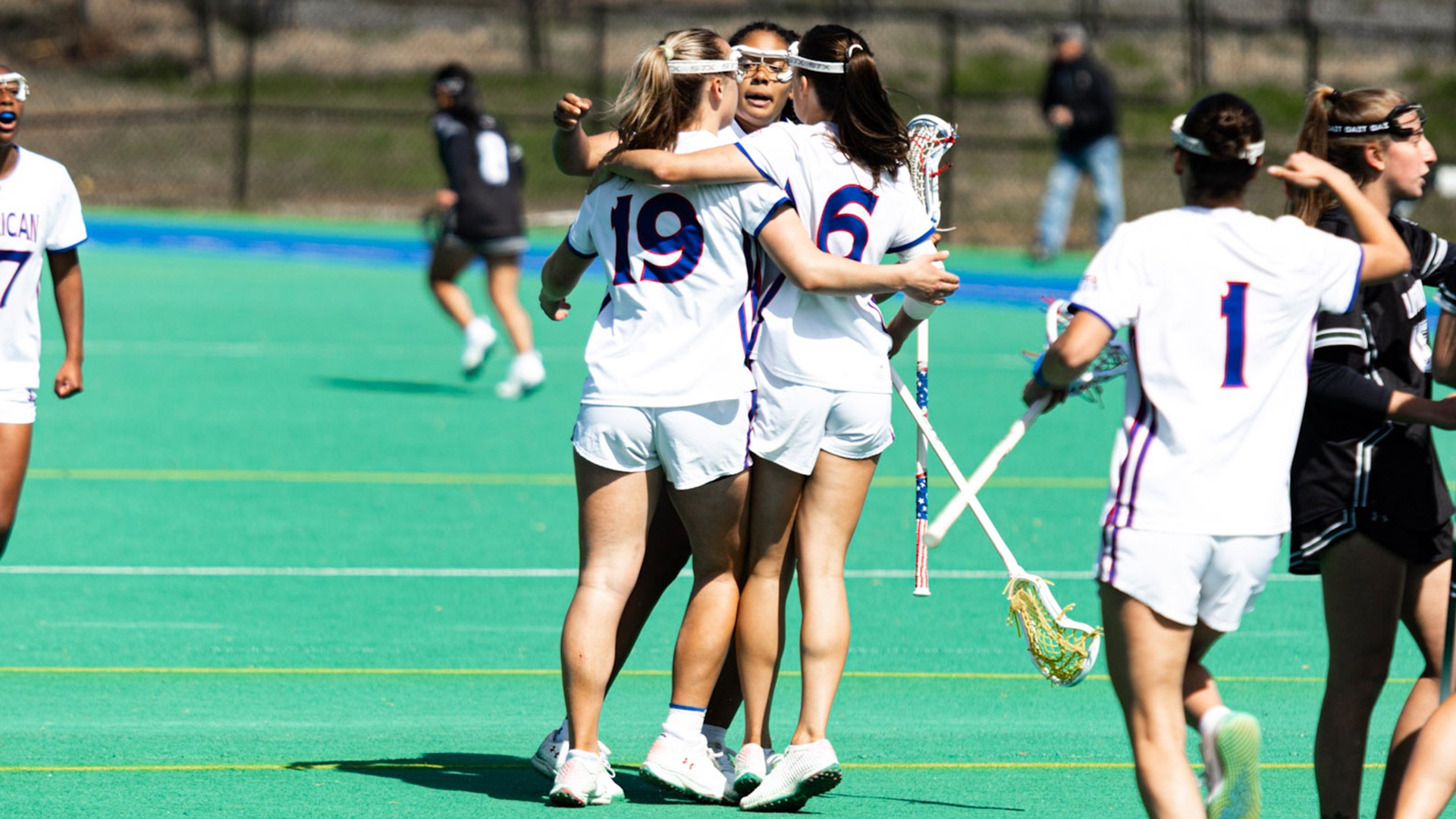 Anastasia Byrnes, Aine Powers, and Jasmine Connor celebrating a goal against Loyola. 